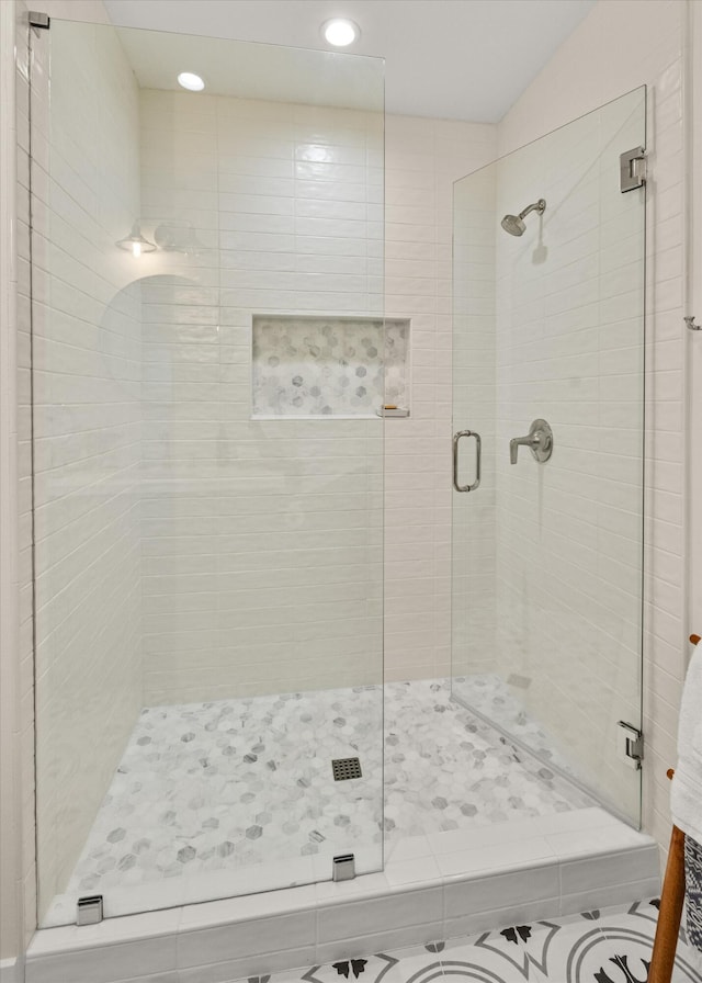 bathroom featuring a shower with shower door