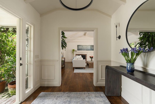 entryway featuring dark hardwood / wood-style floors and vaulted ceiling with beams