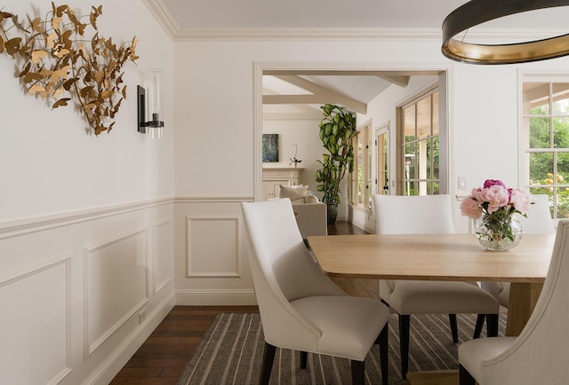 dining room featuring dark wood-type flooring and ornamental molding