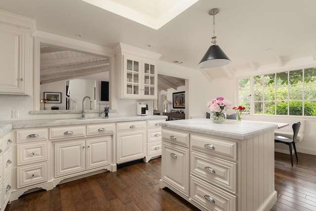 kitchen featuring pendant lighting, backsplash, dark hardwood / wood-style flooring, and vaulted ceiling with beams