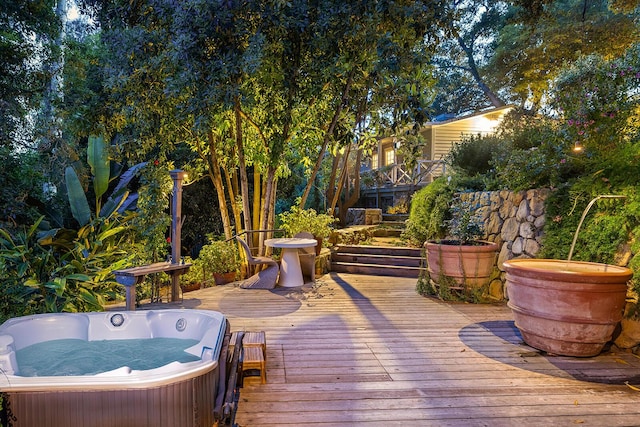 deck featuring an outdoor hot tub