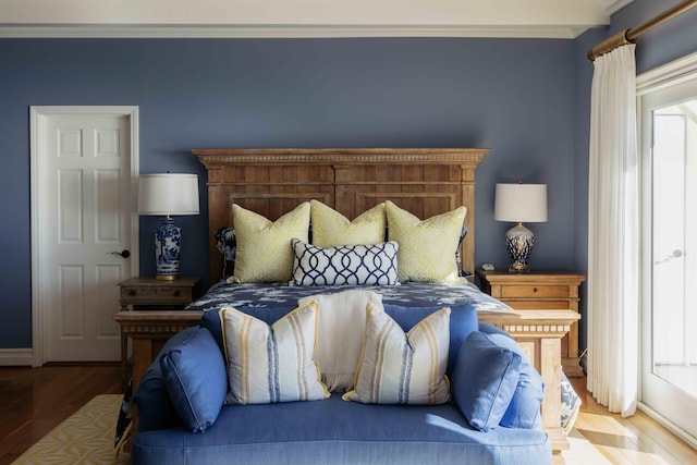 bedroom with hardwood / wood-style floors and crown molding