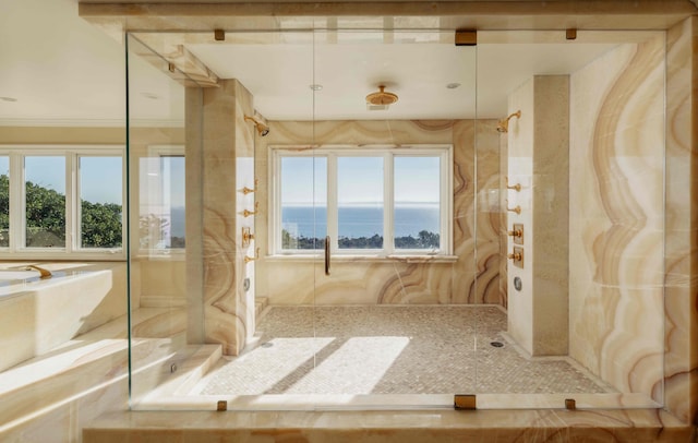 bathroom featuring a water view and tiled shower