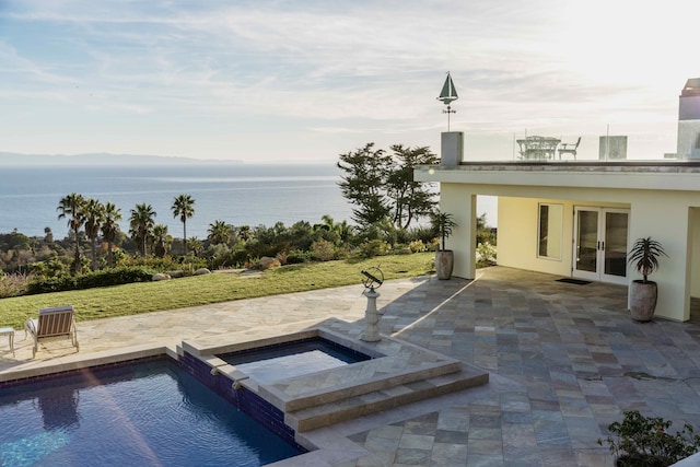 view of pool featuring an in ground hot tub, a patio area, a water view, and french doors