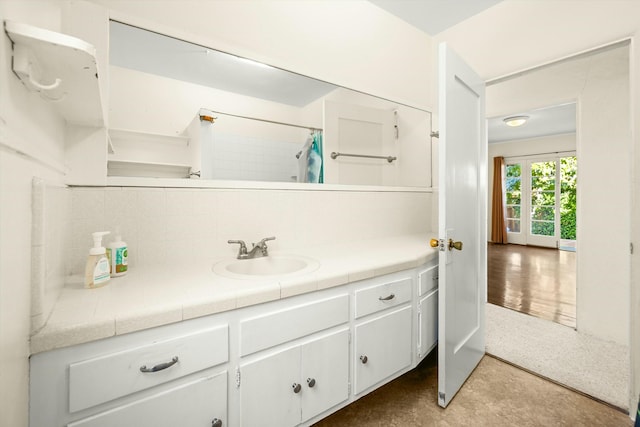 bathroom featuring curtained shower and vanity