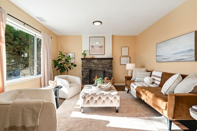 living room featuring a stone fireplace