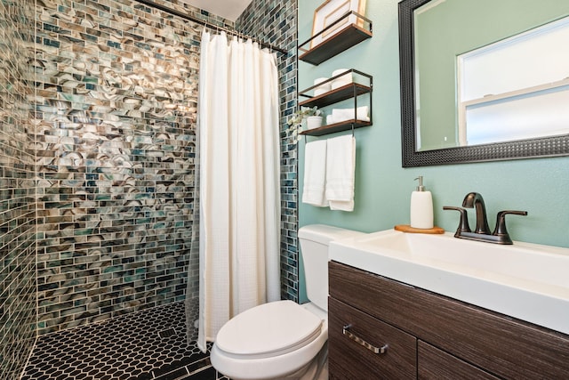 bathroom featuring vanity, toilet, and walk in shower