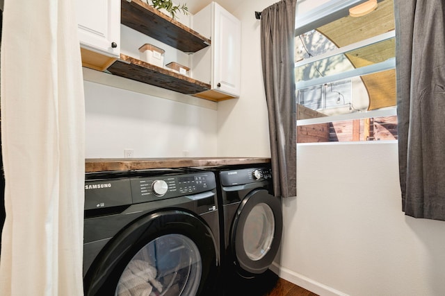 laundry room featuring cabinets and washer and clothes dryer