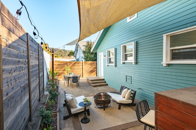 view of patio / terrace featuring an outdoor fire pit