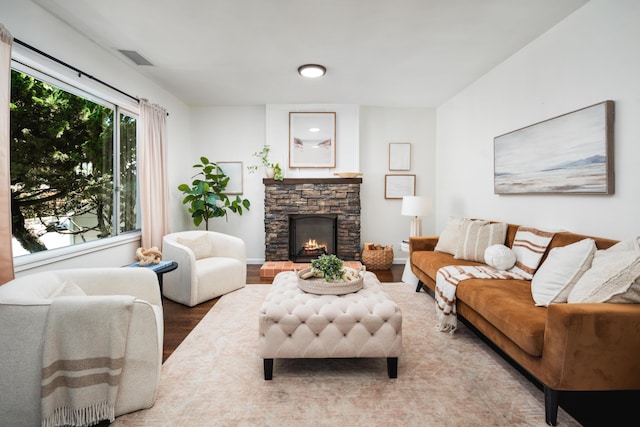 315 E Micheltorena St, Santa Barbara, CA 93101 - living area featuring visible vents, a stone fireplace, and wood finished floors