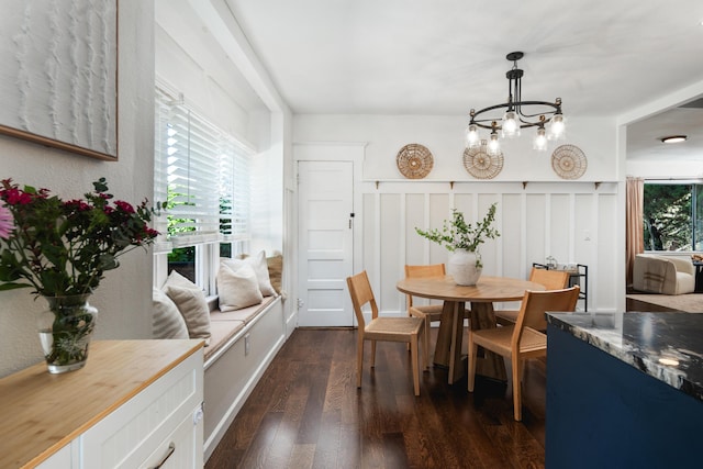 315 E Micheltorena St, Santa Barbara, CA 93101 - dining space with an inviting chandelier, a decorative wall, and dark wood-style floors