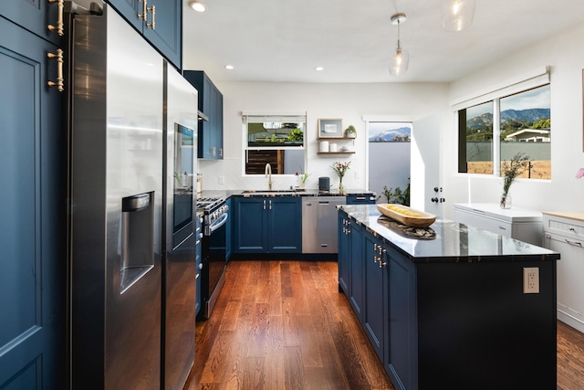 315 E Micheltorena St, Santa Barbara, CA 93101 - kitchen featuring dark wood-style flooring, a kitchen island, a sink, blue cabinetry, and stainless steel appliances