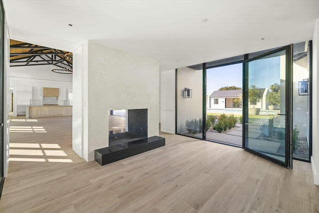 unfurnished living room featuring light hardwood / wood-style floors and floor to ceiling windows