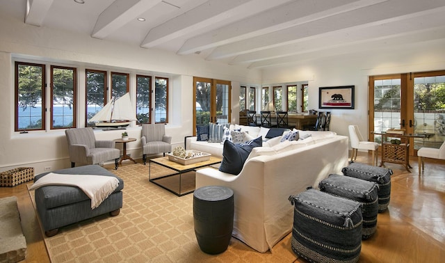 living room with french doors, plenty of natural light, beam ceiling, and light wood-type flooring