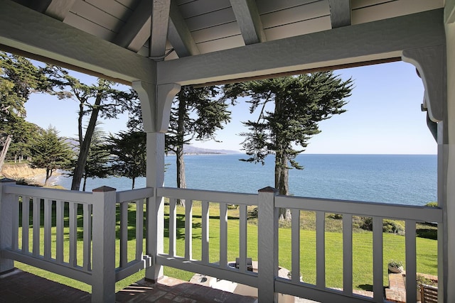 wooden deck featuring a water view and a yard