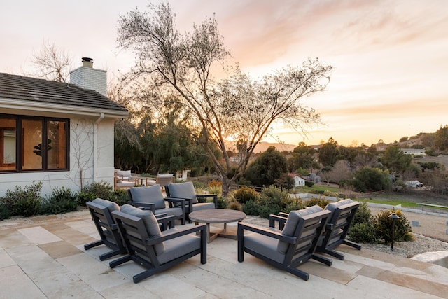 view of patio terrace at dusk