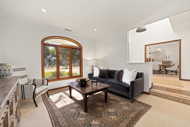 living area featuring light carpet, visible vents, baseboards, ornamental molding, and recessed lighting