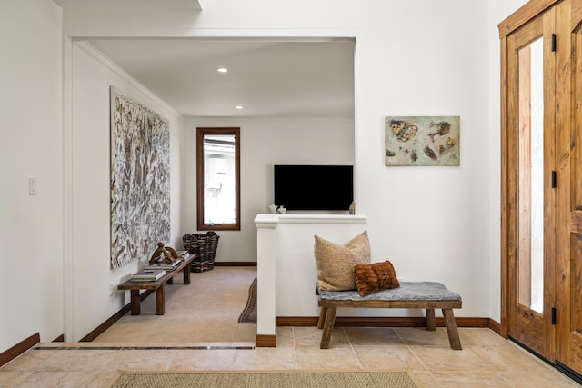 interior space featuring recessed lighting, crown molding, and baseboards