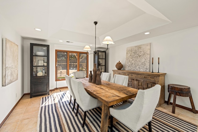 dining area featuring light tile patterned floors, baseboards, a tray ceiling, and recessed lighting