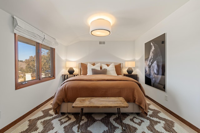 bedroom featuring baseboards, visible vents, and vaulted ceiling