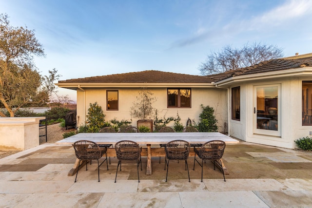 patio terrace at dusk with an outdoor fire pit