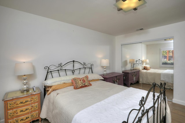 bedroom featuring hardwood / wood-style floors and a closet