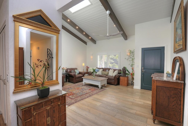 living room featuring high vaulted ceiling, light wood-type flooring, wood ceiling, and beam ceiling