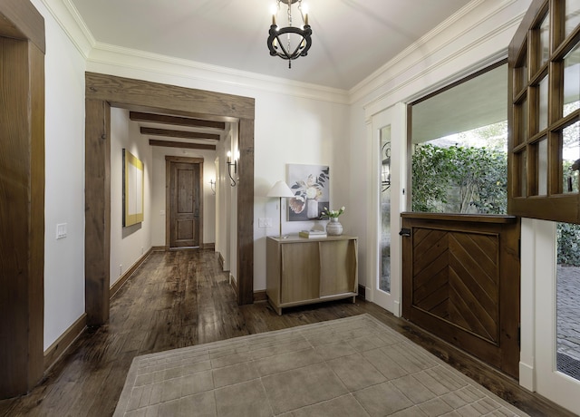 foyer entrance featuring ornamental molding, dark hardwood / wood-style floors, and a chandelier