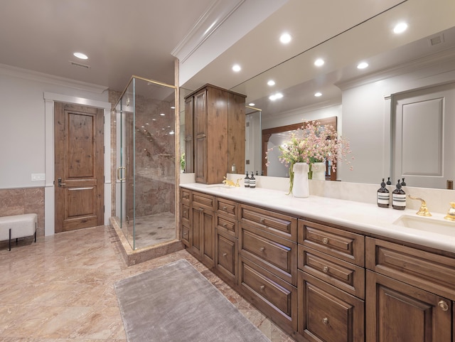 bathroom with crown molding, an enclosed shower, and vanity