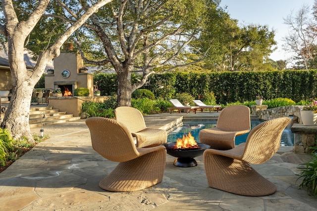 view of patio / terrace featuring exterior fireplace