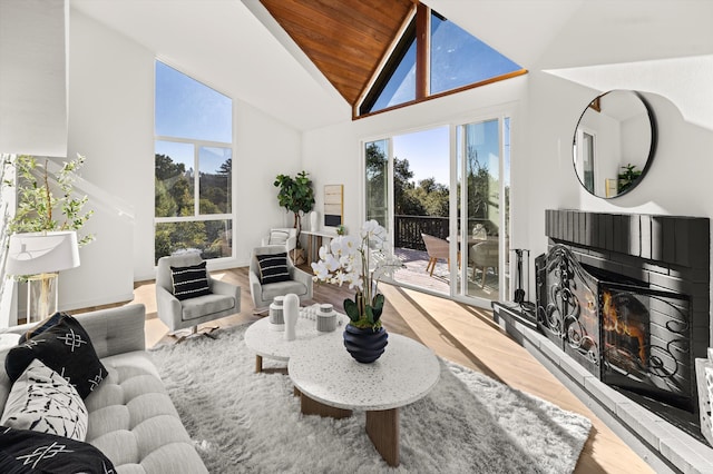 living room with lofted ceiling, hardwood / wood-style floors, and wood ceiling