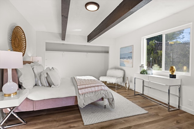 bedroom featuring dark hardwood / wood-style floors and beam ceiling