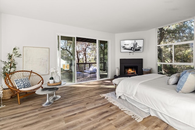 bedroom with hardwood / wood-style flooring and access to exterior