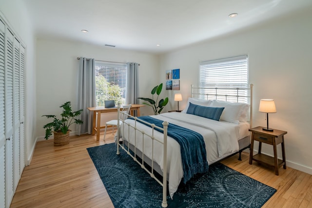 bedroom featuring a closet and light wood-type flooring