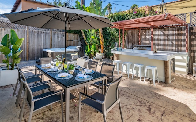 view of patio featuring exterior bar and a pergola