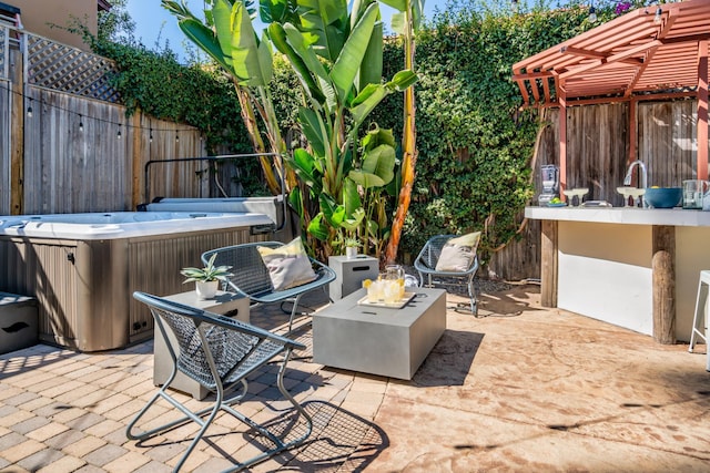 view of patio / terrace with a hot tub