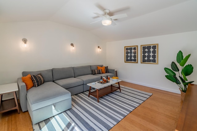 living room featuring lofted ceiling, ceiling fan, and light wood-type flooring