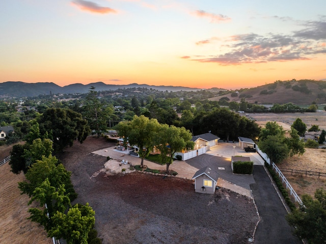 aerial view at dusk featuring a mountain view