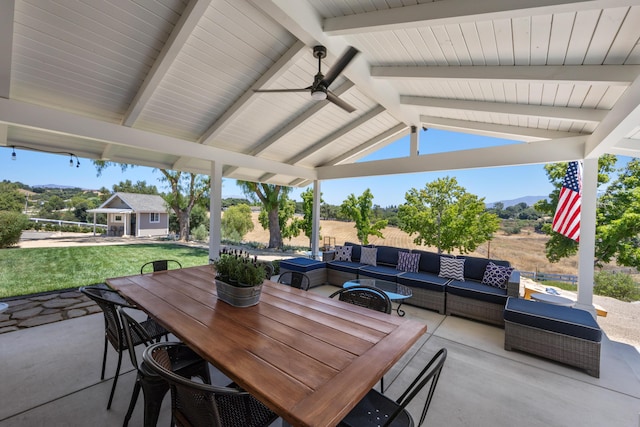 view of patio with a gazebo, an outdoor structure, a mountain view, ceiling fan, and an outdoor living space