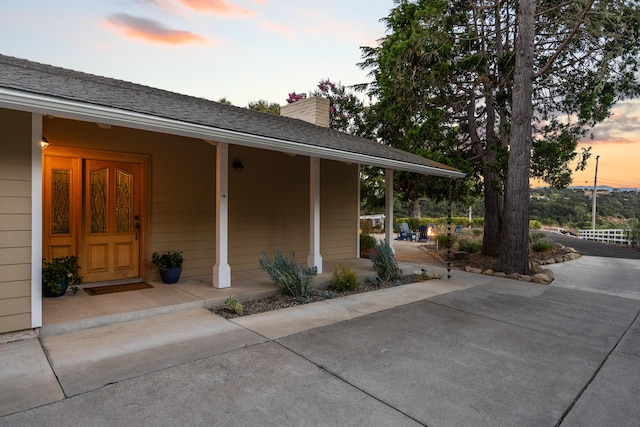 view of exterior entry at dusk