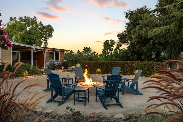 patio terrace at dusk featuring a fire pit