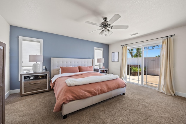 carpeted bedroom with ceiling fan, access to exterior, and a textured ceiling