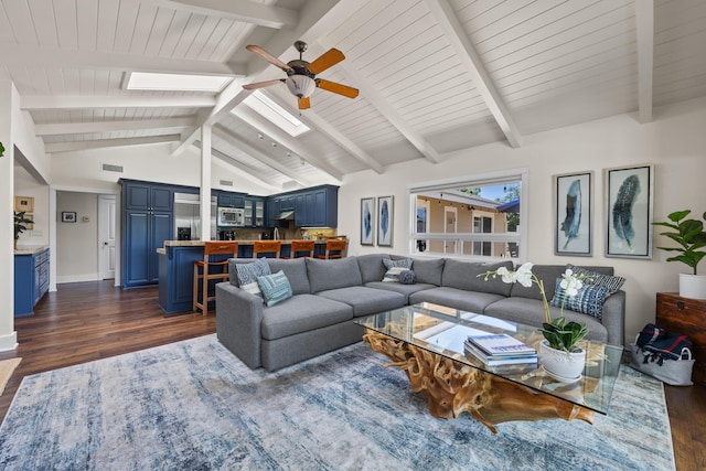 living room featuring lofted ceiling with skylight, dark hardwood / wood-style floors, and ceiling fan