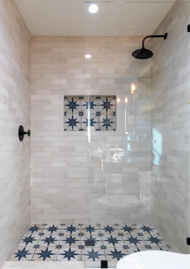 bathroom with a tile shower