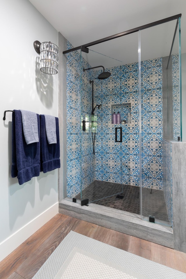 bathroom featuring wood-type flooring and walk in shower