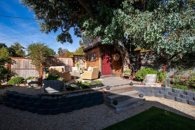 exterior space featuring an outdoor hangout area, an outdoor structure, and a deck