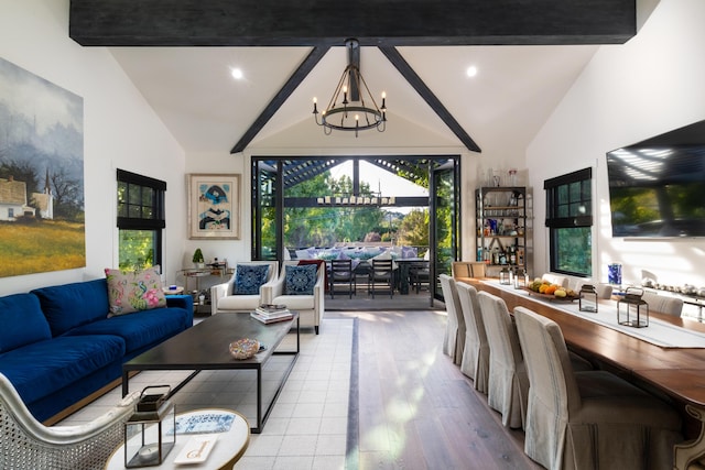 living room featuring vaulted ceiling with beams, a notable chandelier, and light wood-type flooring