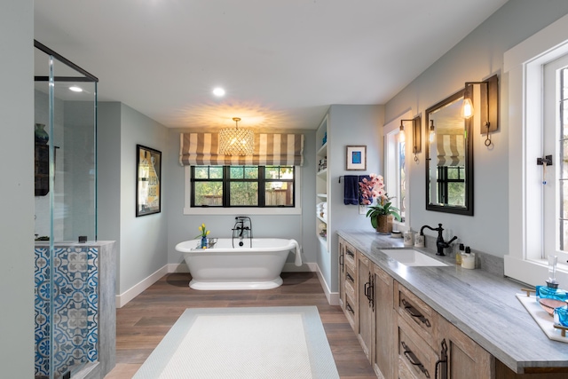 bathroom featuring vanity, separate shower and tub, and hardwood / wood-style floors