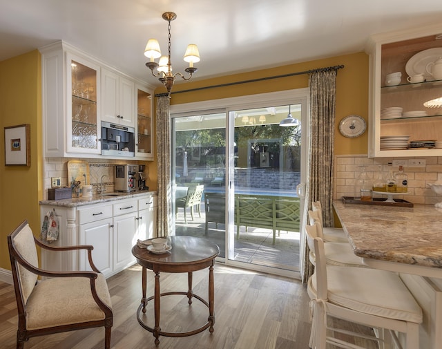 interior space featuring sink, a notable chandelier, and light hardwood / wood-style floors