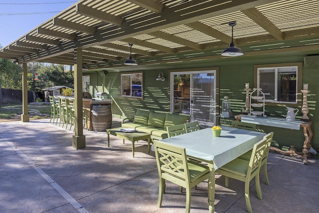 view of patio with outdoor lounge area, exterior bar, and a pergola